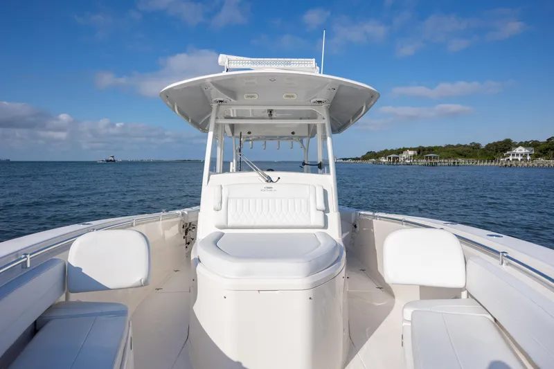 Slide: The Image of 2020 Cobia 350 Center Console boat on calm water under blue sky. - 20