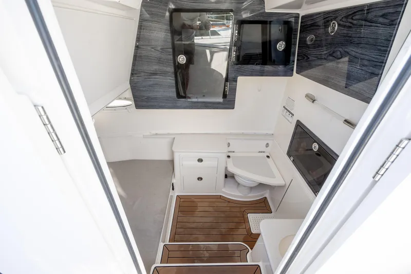 Slide: The Image of 2020 Cobia 350 Center Console cabin interior with modern amenities and wood flooring. - 21