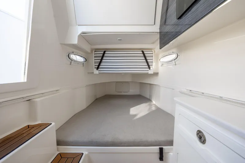 Slide: The Image of Interior cabin of 2020 Cobia 350 Center Console boat, featuring a spacious sleeping area. - 22