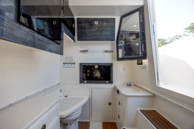Slide: The Image of 2020 Cobia 350 Center Console boat interior with modern amenities and sleek cabinetry. - 23