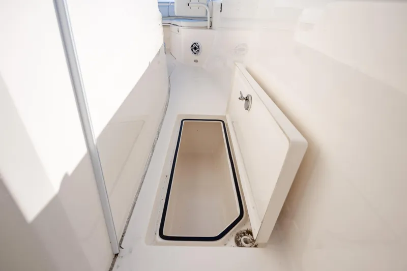 Slide: The Image of 2020 Cobia 350 Center Console boat storage compartment, open and empty. - 25