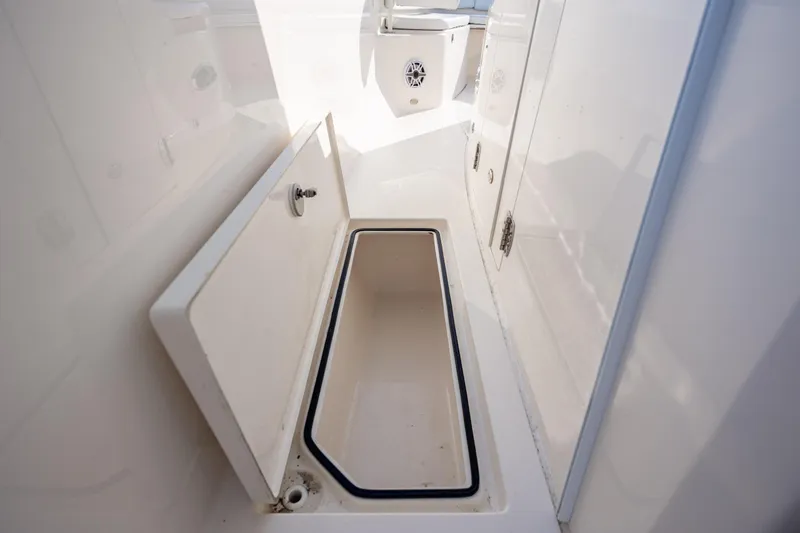 Slide: The Image of Open storage compartment on a 2020 Cobia 350 Center Console boat. - 27