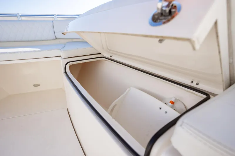 Slide: The Image of Open storage compartment on a 2020 Cobia 350 Center Console boat. - 31