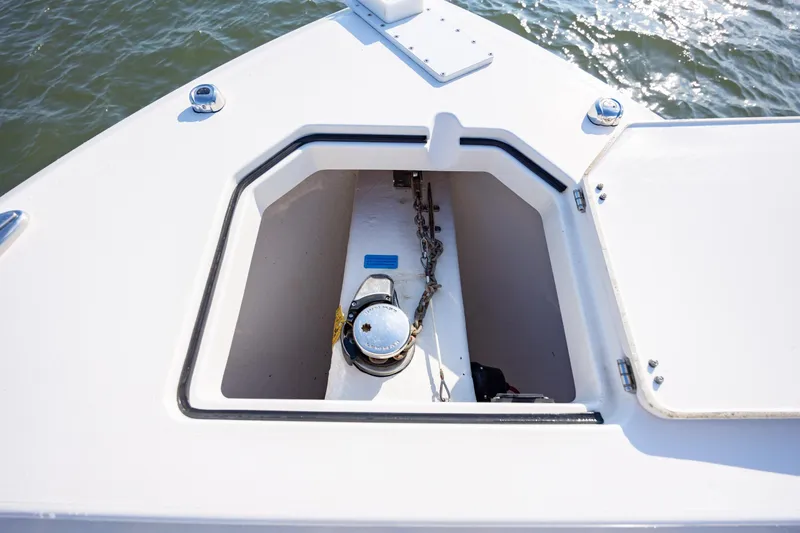 Slide: The Image of Anchor compartment of 2020 Cobia 350 Center Console boat, open hatch, ocean background. - 33