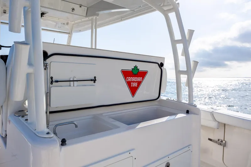 Slide: The Image of 2020 Cobia 350 Center Console boat with Canadian Tire logo, ocean view. - 37