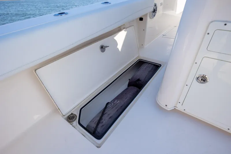Slide: The Image of Storage compartment on a 2020 Cobia 350 Center Console boat, open with visible contents. - 39