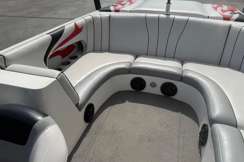 Slide: The Image of 2006 MB SPORTS B52 boat interior with white and gray seating, red accents, and built-in speakers. - 13