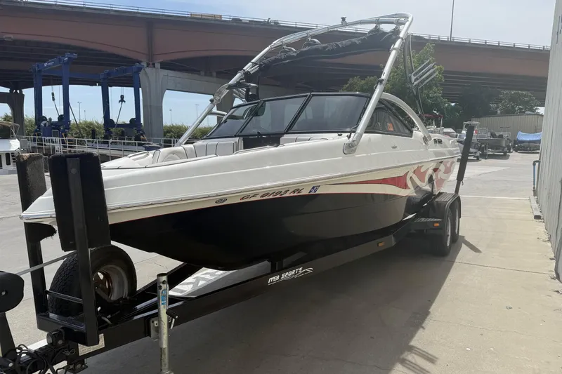 Slide: The Image of 2006 MB SPORTS B52 boat on trailer under bridge, ready for transport. - 3