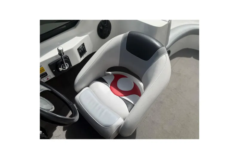 Slide: The Image of Captain's seat of 2006 MB SPORTS B52 boat, featuring sleek design and control panel. - 9