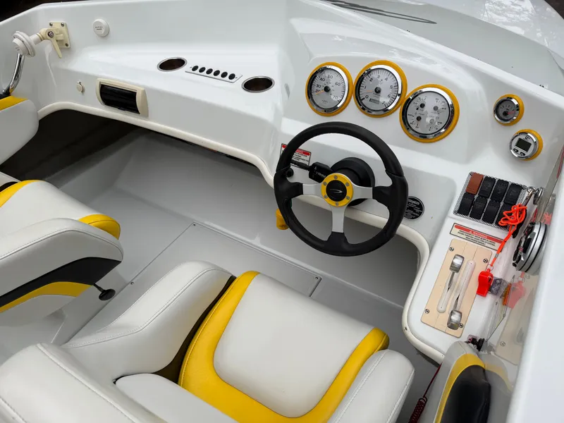 Slide: The Image of Interior of a 2003 Baja 20 Outlaw boat with yellow accents. - 10