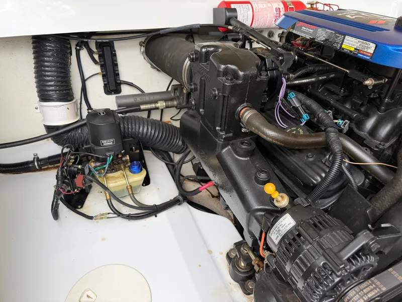 Slide: The Image of Engine compartment of a 2003 Baja 20 Outlaw boat with visible components. - 15