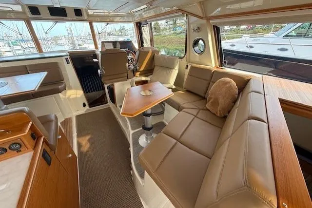 Slide: The Image of Interior of 2022 Ranger Tugs R-43 CB yacht with luxurious seating and wooden accents. - 10