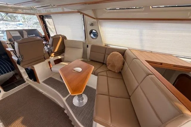 Slide: The Image of Luxurious interior of 2022 Ranger Tugs R-43 CB with plush seating and elegant wood accents. - 11