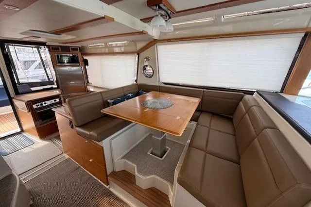 Slide: The Image of Interior of 2022 Ranger Tugs R-43 CB with spacious seating and dining area. - 12