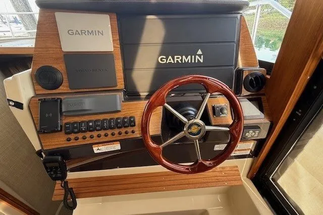 Slide: The Image of Helm of 2022 Ranger Tugs R-43 CB with Garmin navigation system and wooden steering wheel. - 14