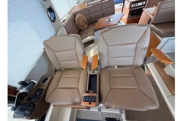 Slide: The Image of Interior of 2022 Ranger Tugs R-43 CB with dual leather seats and control panel. - 15