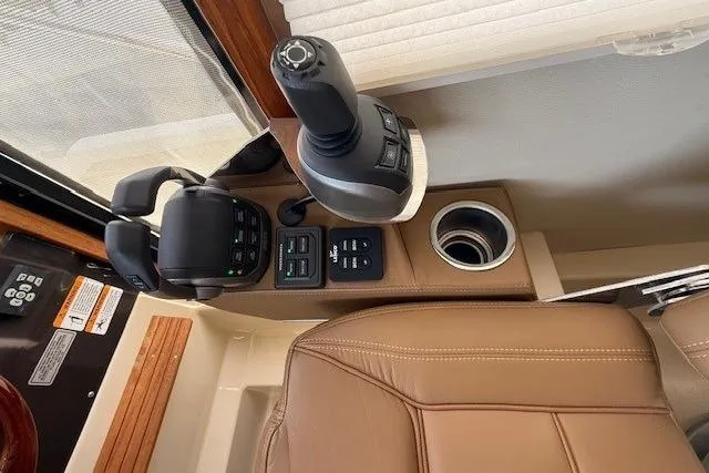 Slide: The Image of Control panel of 2022 Ranger Tugs R-43 CB with joystick and leather seating. - 16