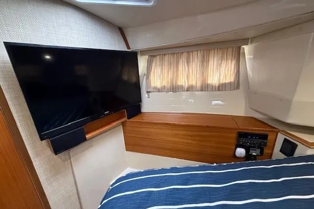 Slide: The Image of Interior cabin of 2022 Ranger Tugs R-43 CB with TV and striped bedding. - 20