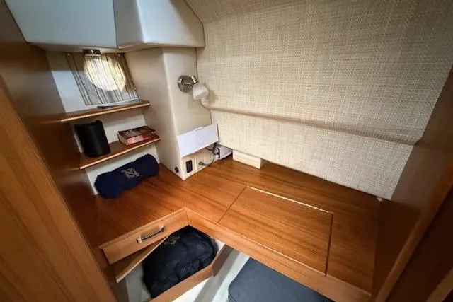 Slide: The Image of Interior cabin of 2022 Ranger Tugs R-43 CB with wooden desk and storage shelves. - 21