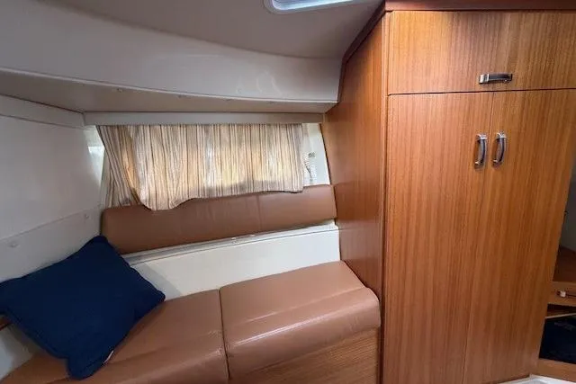 Slide: The Image of Interior of 2022 Ranger Tugs R-43 CB with wood cabinetry and cushioned seating. - 22