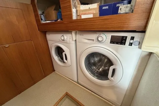 Slide: The Image of Laundry area with washer and dryer inside a 2022 Ranger Tugs R-43 CB boat. - 24