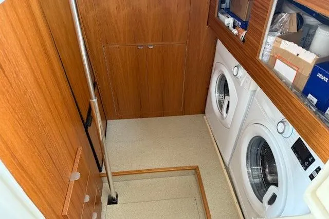 Slide: The Image of Laundry area in 2022 Ranger Tugs R-43 CB boat with washer and dryer. - 25