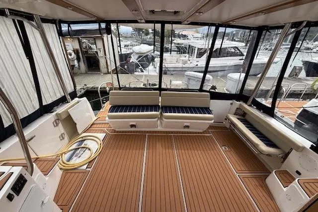 Slide: The Image of Spacious deck of 2022 Ranger Tugs R-43 CB with seating and marina view. - 26
