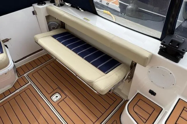 Slide: The Image of 2022 Ranger Tugs R-43 CB boat interior with foldable seating and teak flooring. - 29