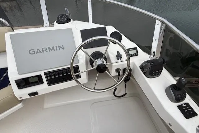 Slide: The Image of Cockpit of 2022 Ranger Tugs R-43 CB with Garmin navigation system and steering wheel. - 30