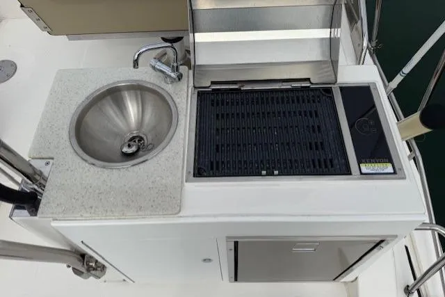 Slide: The Image of Outdoor kitchen on 2022 Ranger Tugs R-43 CB with sink and grill. - 31