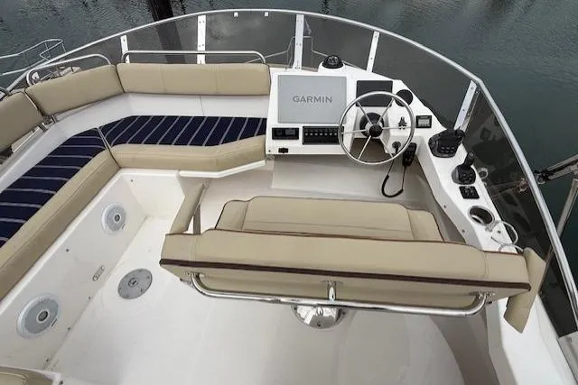 Slide: The Image of Flybridge of 2022 Ranger Tugs R-43 CB with Garmin navigation system and beige seating. - 34