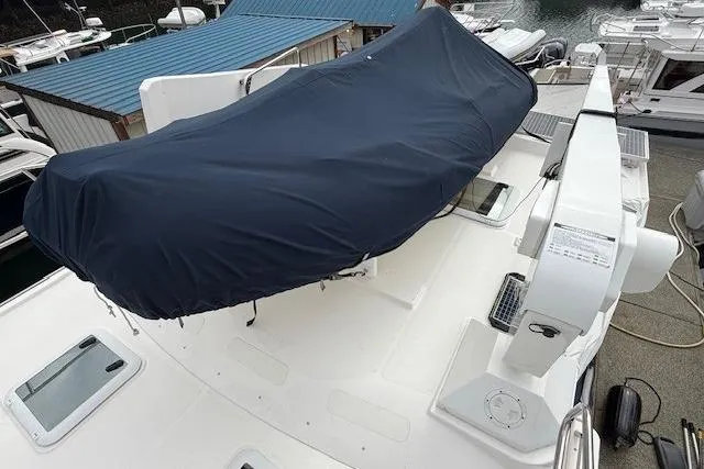 Slide: The Image of 2022 Ranger Tugs R-43 CB boat deck with covered equipment, docked at marina. - 35