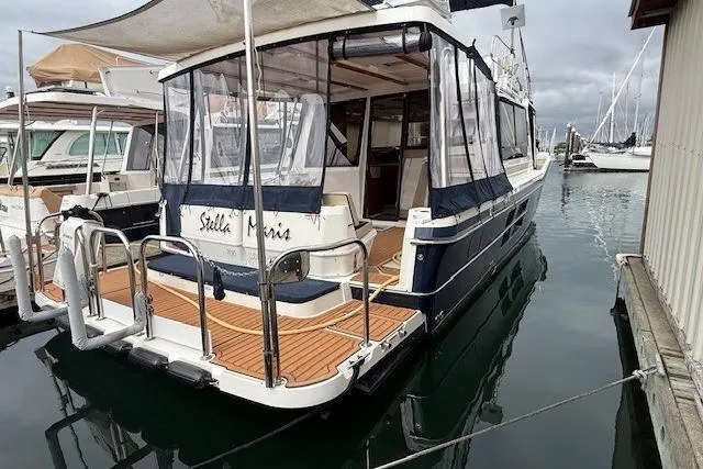 Slide: The Image of 2022 Ranger Tugs R-43 CB yacht docked at marina, rear view with covered deck. - 38