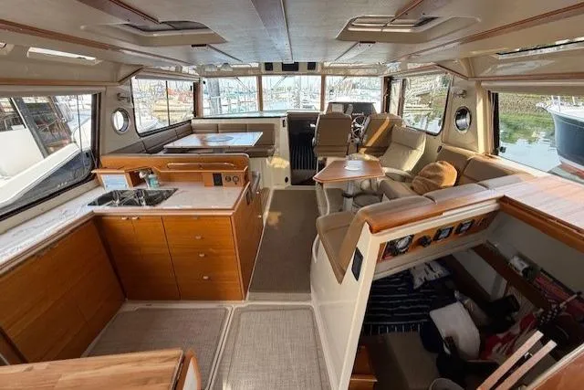 Slide: The Image of Interior of 2022 Ranger Tugs R-43 CB yacht, featuring spacious seating and modern kitchen amenities. - 7