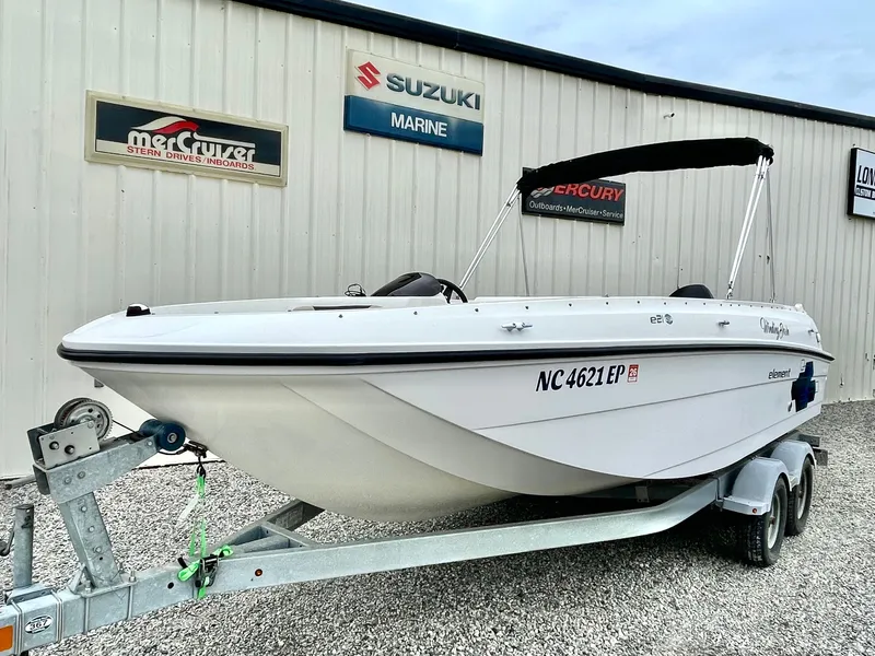 The Image of 2017 Bayliner E21 boat on trailer in front of building. - 0