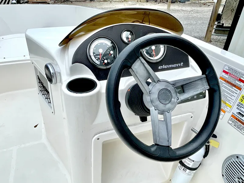 Slide: The Image of 2017 Bayliner E21 boat steering console with wheel and gauges. - 12