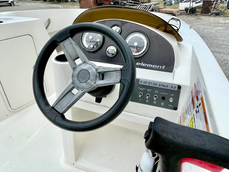 Slide: The Image of Steering wheel and dashboard of a 2017 Bayliner E21 boat. - 14