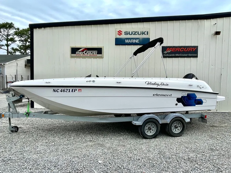 Slide: The Image of 2017 Bayliner E21 boat on trailer outside Suzuki Marine building. - 2