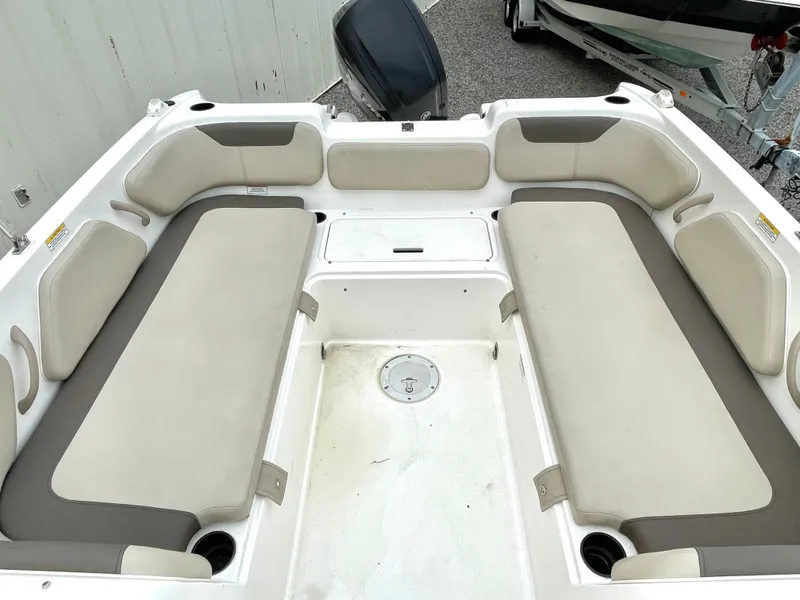 Slide: The Image of Interior of a 2017 Bayliner E21 boat with seating area. - 24