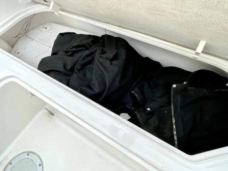 Slide: The Image of Storage compartment in Bayliner E21 boat with black fabric. - 27