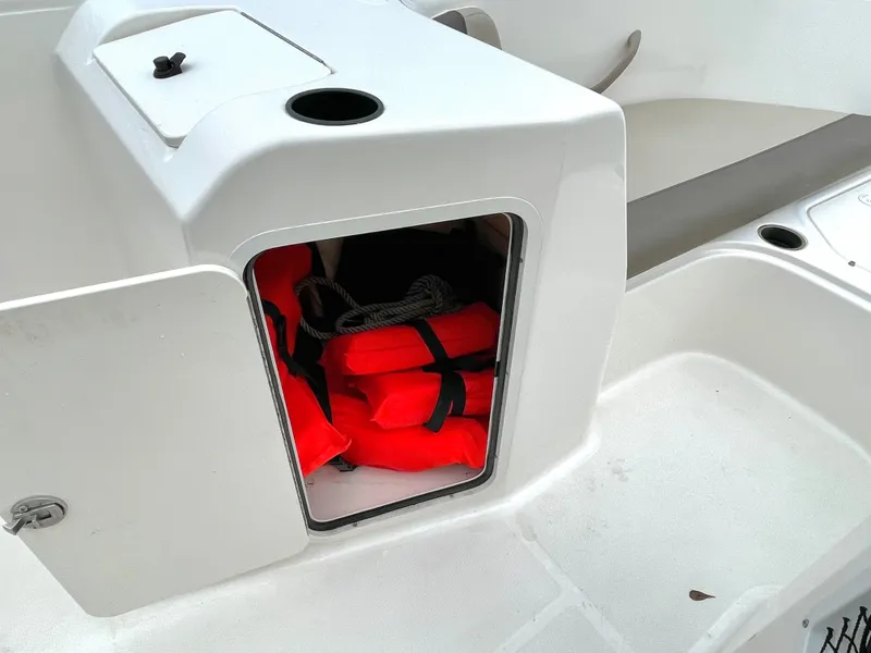 Slide: The Image of Red life jackets in storage compartment of a 2017 Bayliner E21 boat. - 30