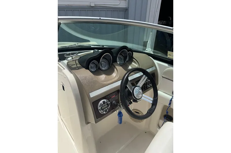 Slide: The Image of 2013 Sea Ray 280 Sundeck dashboard with steering wheel and instrument panel. - 12