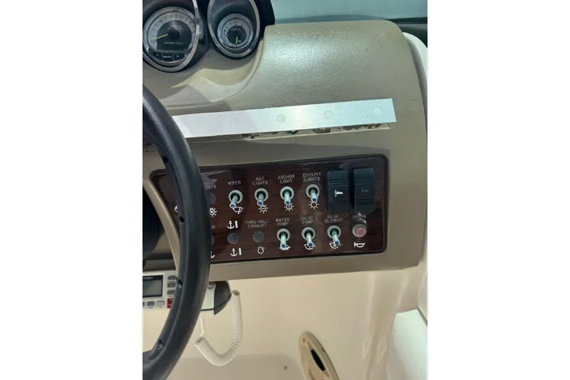 Slide: The Image of Control panel of a 2013 Sea Ray 280 Sundeck boat with various switches and gauges. - 16