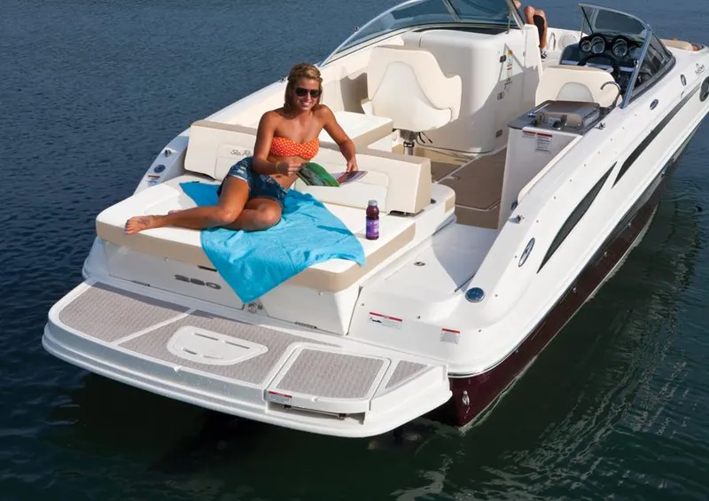 Slide: The Image of Manufacturer Provided Image: 2013 Sea Ray 280 Sundeck with a woman relaxing on the deck in the water. - 2