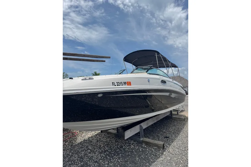Slide: The Image of 2013 Sea Ray 280 Sundeck boat on trailer under blue sky. - 24