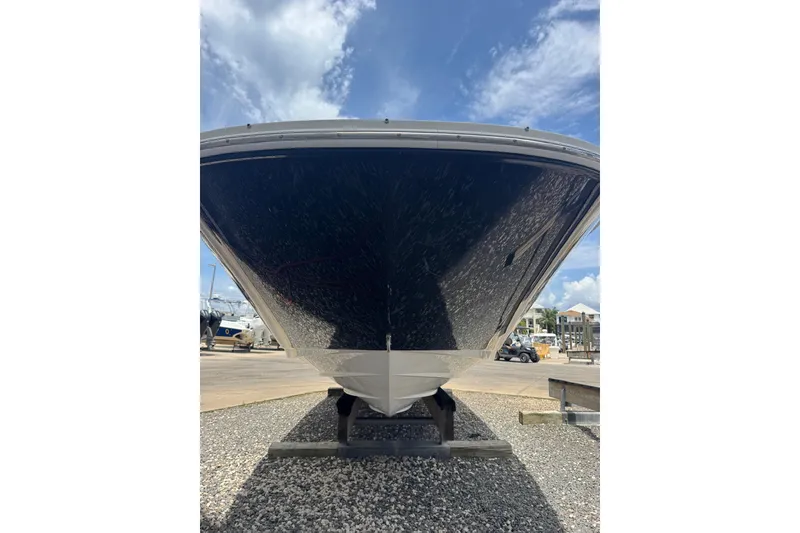 Slide: The Image of 2013 Sea Ray 280 Sundeck boat on dry dock under a clear blue sky. - 25
