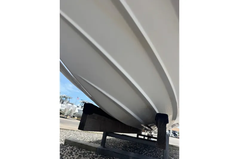 Slide: The Image of 2013 Sea Ray 280 Sundeck boat hull on a trailer, viewed from below. - 26