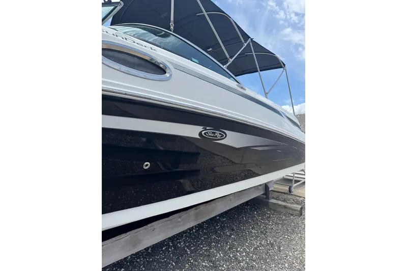 Slide: The Image of 2013 Sea Ray 280 Sundeck boat with canopy, viewed from below against a blue sky. - 27