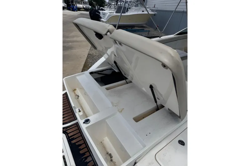 Slide: The Image of 2013 Sea Ray 280 Sundeck boat with open storage compartments on deck. - 32