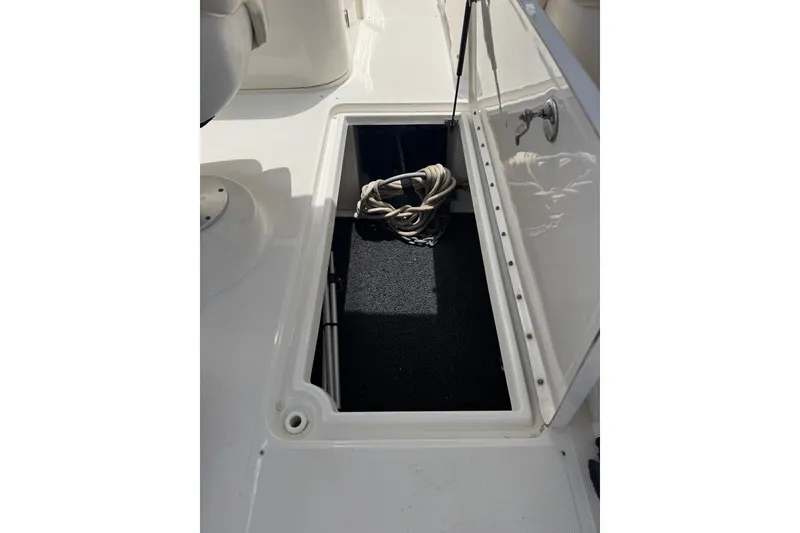 Slide: The Image of Open storage compartment on 2013 Sea Ray 280 Sundeck boat with coiled rope inside. - 36